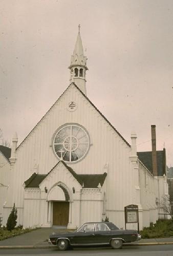 General view of the Church of Our Lord, showing the Gothic arched entrance and vestibule, and the spire-topped belfry, 1991.; Parks Canada Agency / Agence Parcs Canada, 1991.