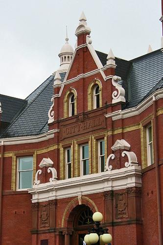 General view of Stratford City Hall, showing its use of a variety of materials, colours, shapes and textures, in keeping with the stylistic eclecticism, 2011.; Stratford City Hall, Corey Seeman, 2011.