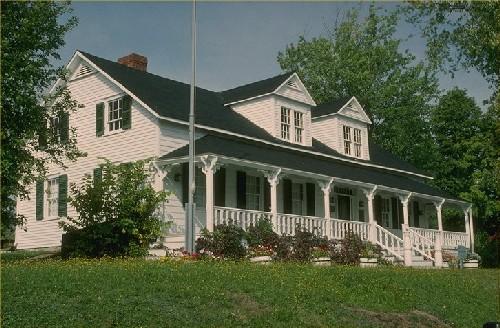 General view of Tilley House, showing the one-and-a-half-storey massing under a front-sloped pitched roof with twin chimneys, 1987.; Parks Canada Agency / Agence Parcs Canada, 1987.