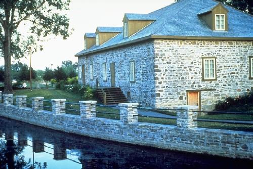View of the exterior of the building, showing its rectangular single storey massing under a hipped roof.; Parks Canada Agency / Agence Parcs Canada.