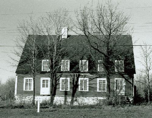 View of the Pagé - Rinfret House / Beaudry House, showing the placement of chimneys and dormers within the slope of the roof, 1969.; Parks Canada Agency / Agence Parcs Canada, 1969.