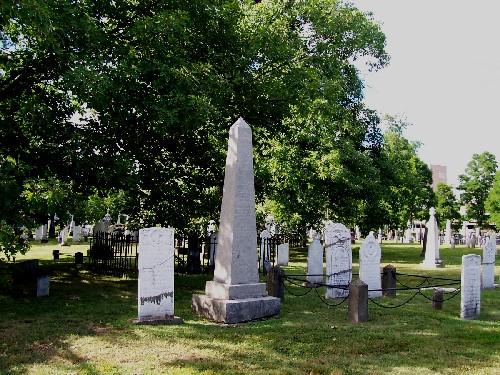 Old Burial Ground section near George Street gate showing fenced tombstones and landscape; City of Fredericton