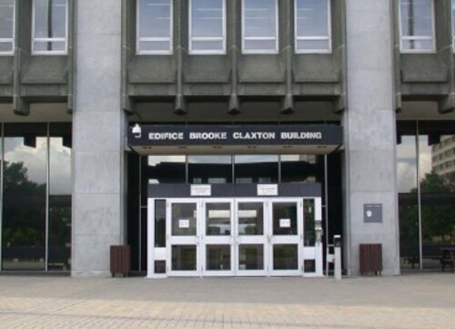 General view of the Brooke Claxton Building, showing the centrally placed main entrance surrounded by a studied mix of glass and black granite walls, 2004.; Public Works and Government Services Canada / Travaux publics et Services gouvernementaux Canada, 2004.