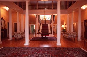 Interior view of Government House, showing its centre hall and large staircase, 1995.; Parks Canada Agency / Agence Parcs Canada, J. Butterhill, 1995.