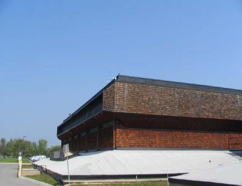 View of the exterior of Block 1800, showing its wood shingles, set on a pyramidal base with a heavy, box-like, overhanging roof, 2005.; Parks Canada Agency / Agence Parcs Canada, Kate MacFarlane, 2005.