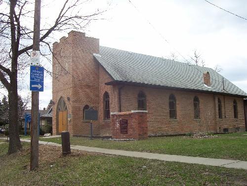 Corner view of Sandwich First Baptist Church, showing its locally-made brick construction materials with wood framing of doors and windows.; Parks Canada Agency / Agence Parcs Canada.
