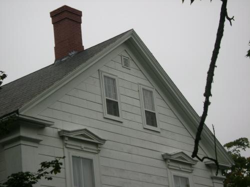 This photograph shows the side view and illustrates the large eave returns and wide cornerboards, 2007; Town of St. Andrews