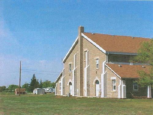 View of the entrance of the Recreational Hall, showing the round-arched doorways and flat-arched windows, all with accentuated keystones, 2003.; Department of National Defence / Ministère de la Défense nationale, 2003.