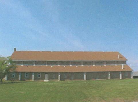 View of the exterior of the Recreational Hall, showing the regular pattern of fenestration, 2003.; Department of National Defence / Ministère de la Défense nationale, 2003.