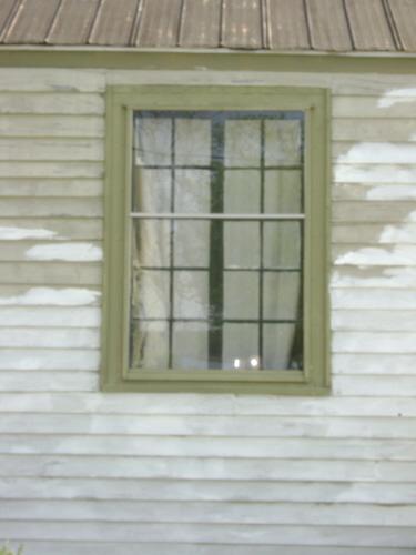 This photograph shows a multi paned wood framed window, 2008; Town of St. Andrews