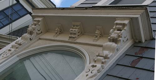 This image shows a view of the carpentry ornamentation of the entablature over the main entrance; City of Saint John, 2007