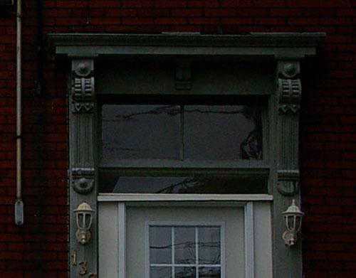 This image shows Italianate detailing in the entranceway above door, the transom and the entablature; City of Saint John