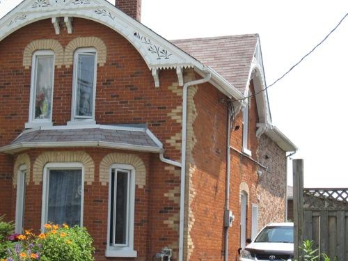 Of note is the bay window with mansard style roof.; Beatrice Tam, 2008.