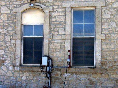 Featured are the carved stone window surrounds and randomly-coursed limestone wall.; Mary Tivy, 2008.