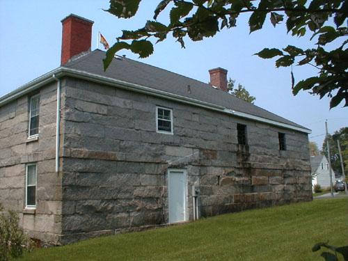 This rear elevation includes a door and three window openings on the second level.; PNB 2004
