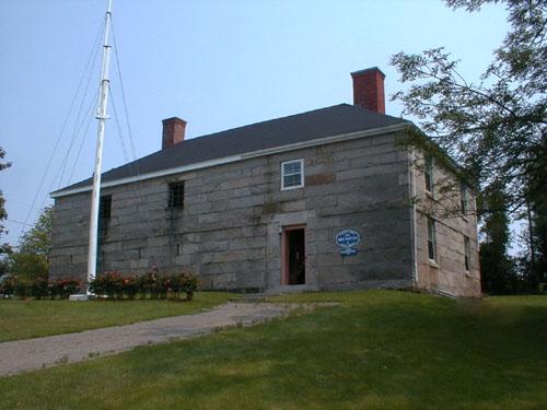 This front elevation includes a door and three window openings on the second level.; PNB 2004