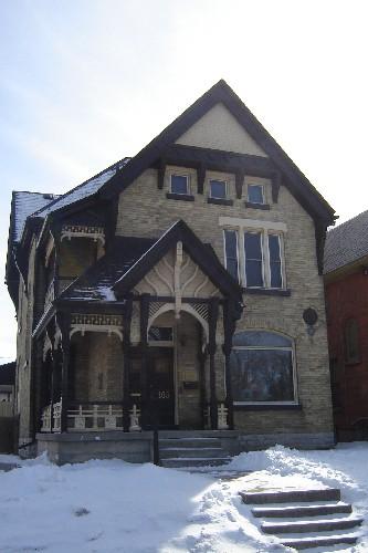 Of note is the extensive decoration on the porch gable and balcony.; Kayla Jonas, 2008.