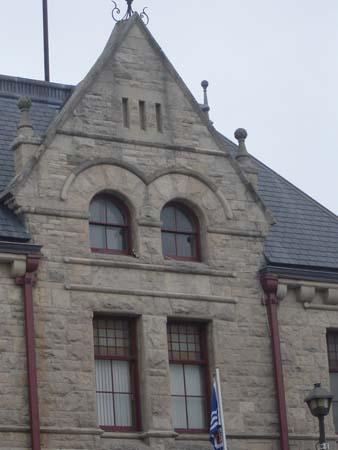 Featured is the massive pediment on the façade, topped by finials.; Kayla Jonas, 2007.