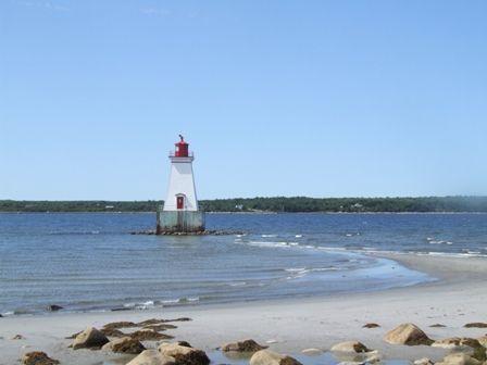 View of the Sandy Point Lighthouse, Shelburne, Nova Scotia, and the sand spit that it rests on.  It is only accessible by foot during lowtide.; Heritage Property Program, Nova Scotia Heritage Division, 2009