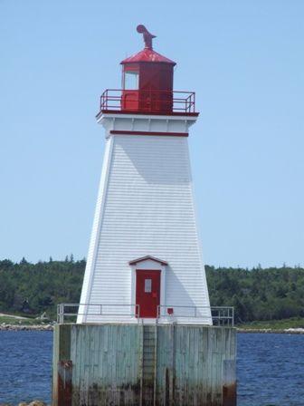 The door of the Sandy Point Lighthhouse, Shelburne, Nova Scotia, faces the shore for emergency purposes.; Heritage Property Program, Nova Scotia Heritage Division, 2009