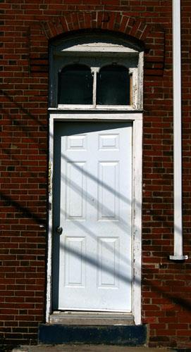 Doorway showing original brickwork and woodwork on Queen Street façade; City of Saint John
