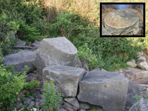 Remains of stones of the Beaumont Quarry consisting of two partially cut grindstones; Memramcook Valley Historical Society