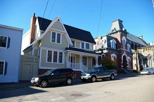 This image shows the Craftsman massing, the shallow cross-gable and the window proportions; City of Saint John
