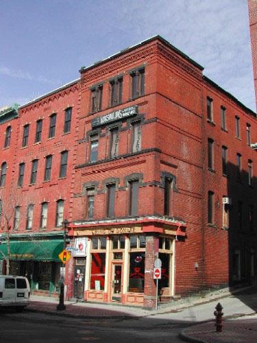 This image shows a full contextual view of the building showing the recessed brick courses on Grannan Street and the relationship the building has with the neighboring building on Prince William Street; City of Saint John 2004