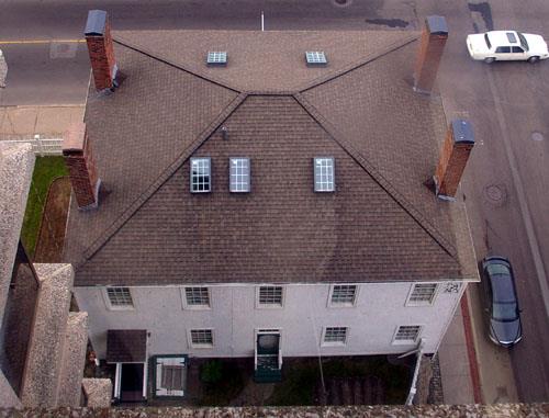 Aerial view showing the roof, the square massing and the symmetrical window arrangement on the rear façade; City of Saint John