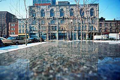 Panoramic view of the Monument National showing its eclectic Renaissance-style construction and four-story rectangular massing, 1994.; Parks Canada Agency / Agence Parcs Canada, P. St. Jacques, 1994.