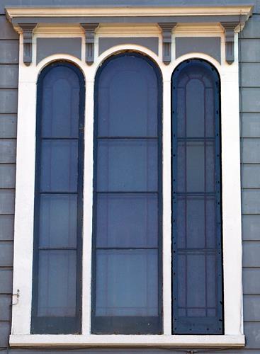 This image shows the tripartite mid-storey window in the central bay of the rear façade. It has etched glass in a Victorian floral pattern; City of Saint John