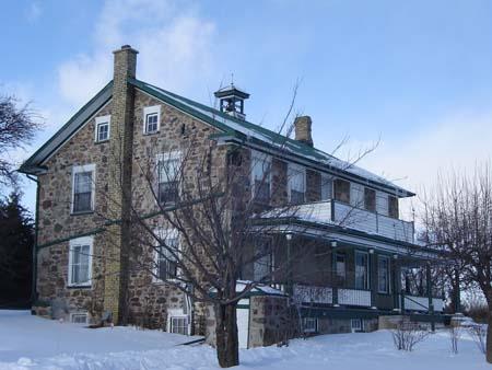 East elevation and front façade, featuring the bell-tower, and the veranda, 2007.; Lindsay Benjamin, 2007.