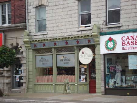 Of note are the intricate woodwork, large storefront windows, and recessed entranceway.; Martina Braunstein, 2007.