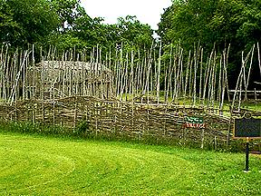Lawson site reconstructed  palisade and longhouse.; London Museum of Archaeology, 2003