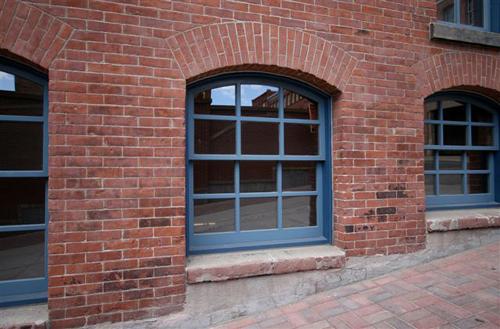 This image shows the street-level windows along the side of the building.; Commercial Properties Limited