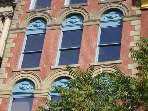 This image shows the elaborate detail of the windows on the front façade.; Commercial Properties Limited