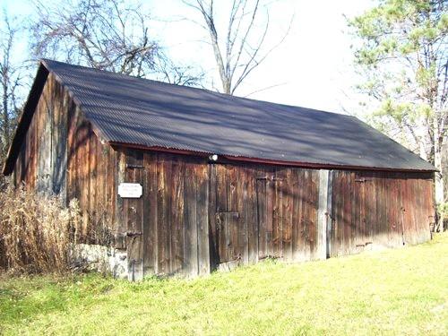 Featured is the frame and vertical board exterior drive shed.; Sally Drummond, 2008.