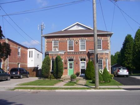 Of note is the symmetrical facade, typical of the Syndicate Housing HCD.; Kirsten Pries, 2008.