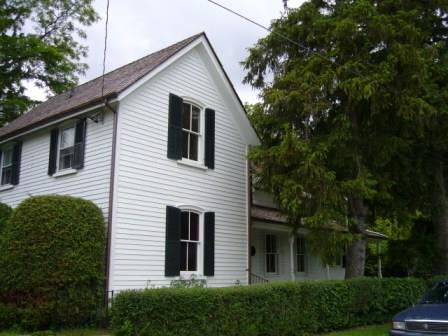 Of note are the two-over-two double hung windows with shutters.; Kirsten Pries, 2008.