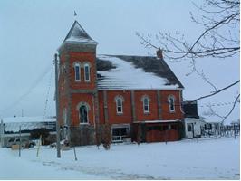 Of note are the paired windows in the tower.; Municipality of Huron East, 2008.