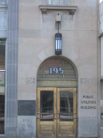 View of one main entrance depicting arched entranceway, brass doors and unique light fixtures.; Lindsay Benjamin, 2007.
