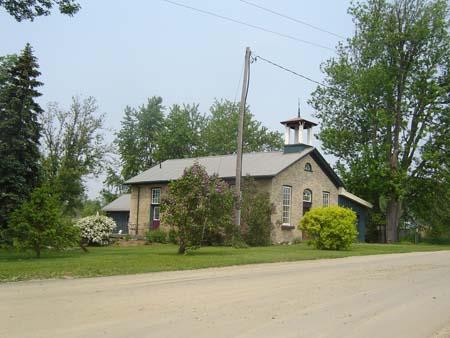 Of note are the wooden belfry and the gable roof.; Kayla Jonas, 2007.
