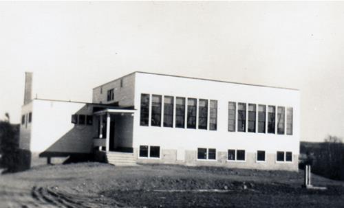 This historic image shows the building when it was used as the Cambridge Rural High School; Queens County Heritage Collection