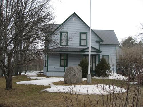 This image shows the front façade of the residence; Village of Cambridge-Narrows