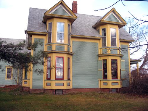 This image shows the two bay windows on the south façade of the residence; Village of Cambridge-Narrows