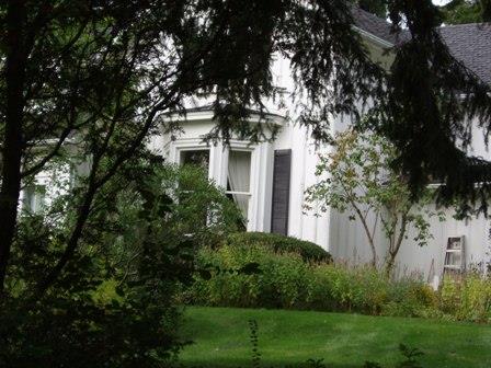 Featured is the first storey bay window with shutters on the west elevation.; Paul Dubniak, 2009.