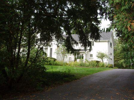 Of note is the board and batten cladding and symmetrical window fenestration.; Paul Dubniak, 2009.