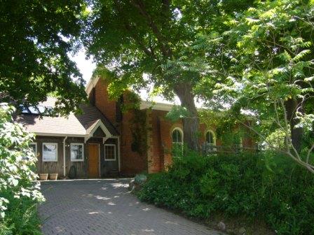Of note is the lush landscaping and mature maple trees surrounding the schoolhouse.; Kirsten Pries, 2008.