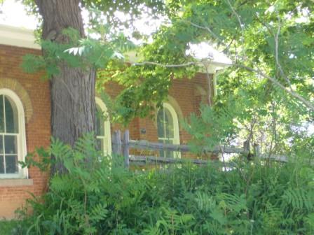 Of note are the two-over-two paned windows with buff brick voussoirs.; Kirsten Pries, 2008.