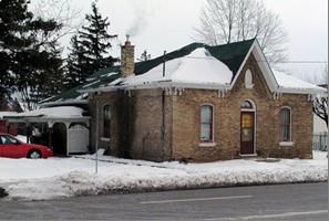 Of note are the raised brick frieze with paired brackets and the stained glass transom.; City of Brantford, n.d.